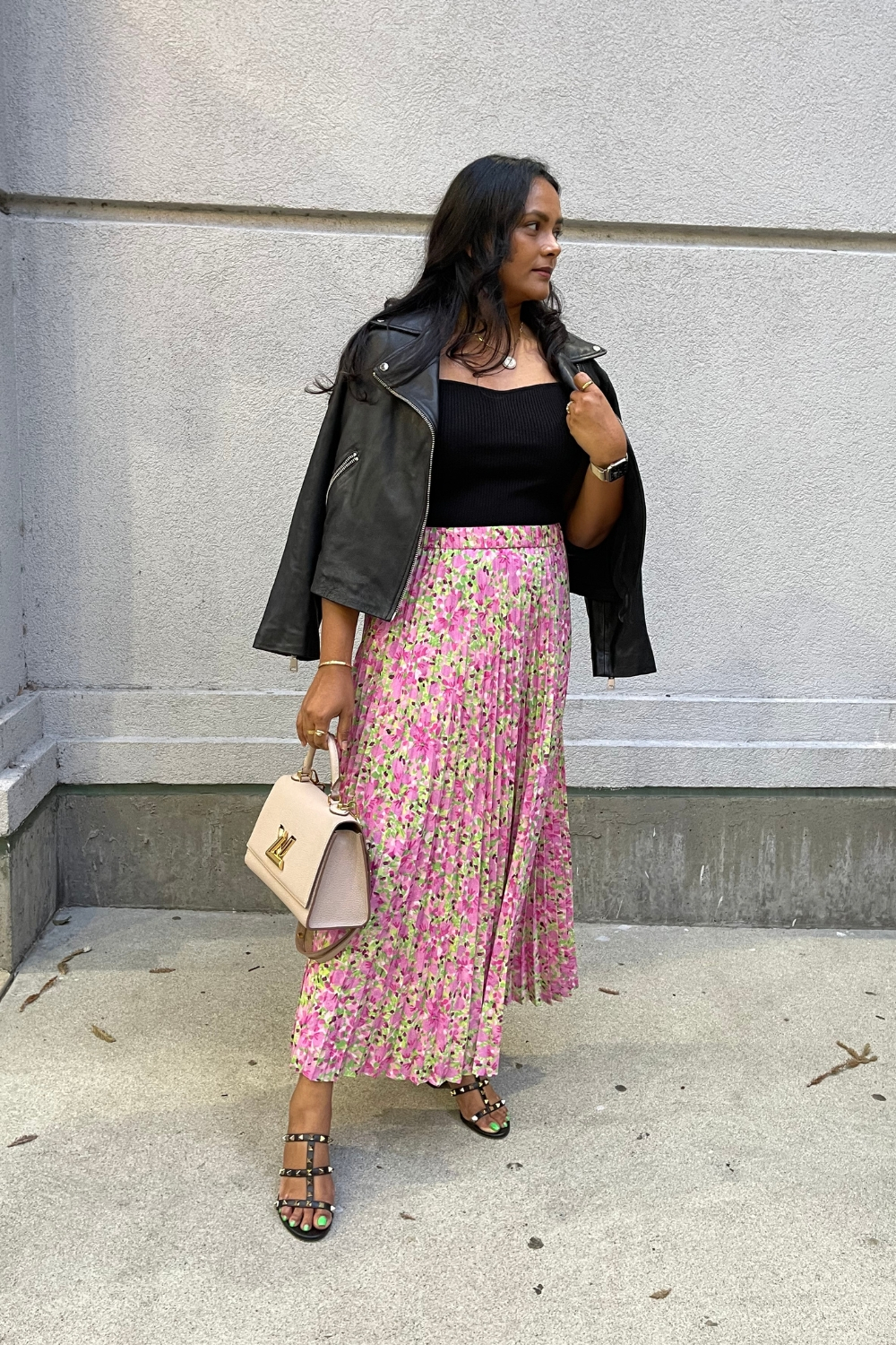 Printed pleated skirt with black leather jacket outfit