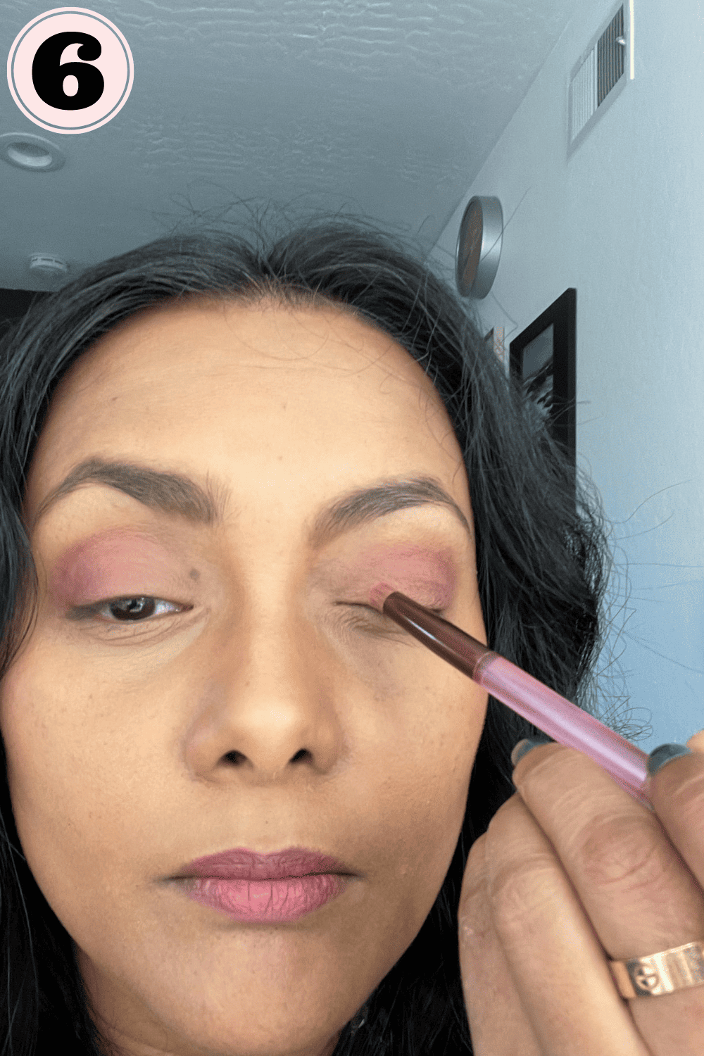 Applying lighter eyeshadow to my inner corner of eye lid
