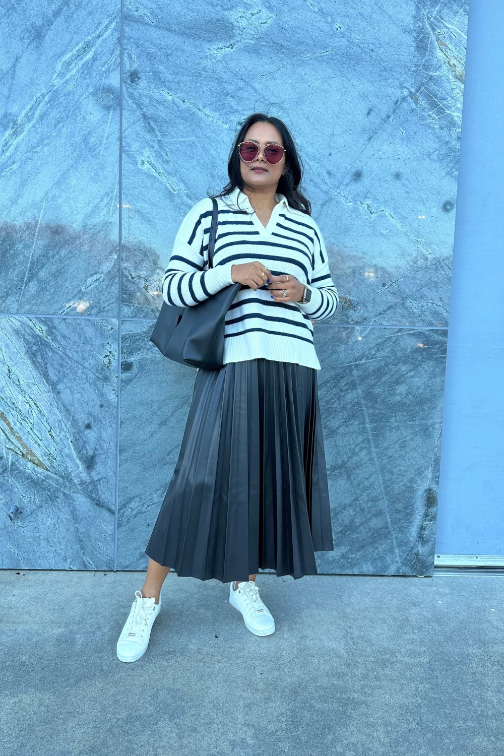 White striped sweater with black skirt and sneakers for fall