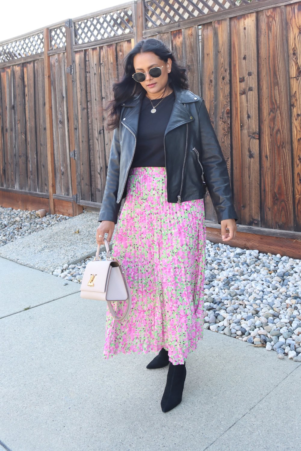 Pleated skirt outfit with black leather jacket