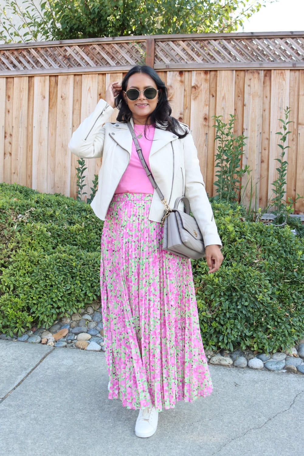 Pleated skirt outfit with white leather jacket