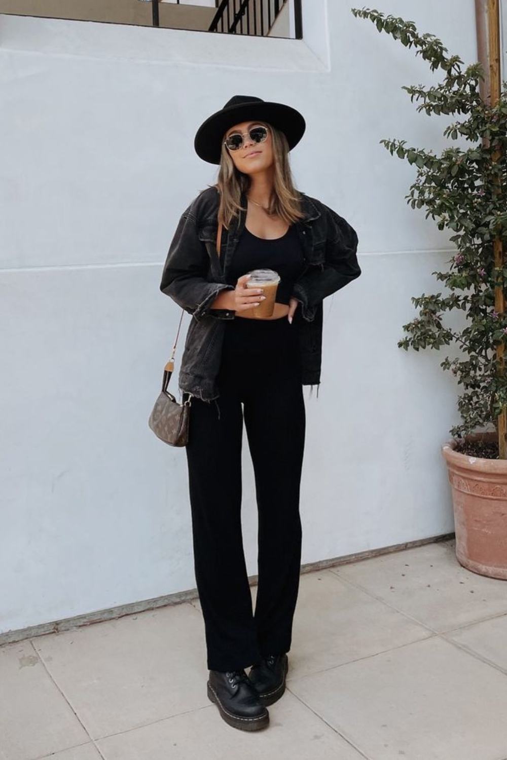 Fedora hat outfit with black tee wide leg jeans and denim jacket