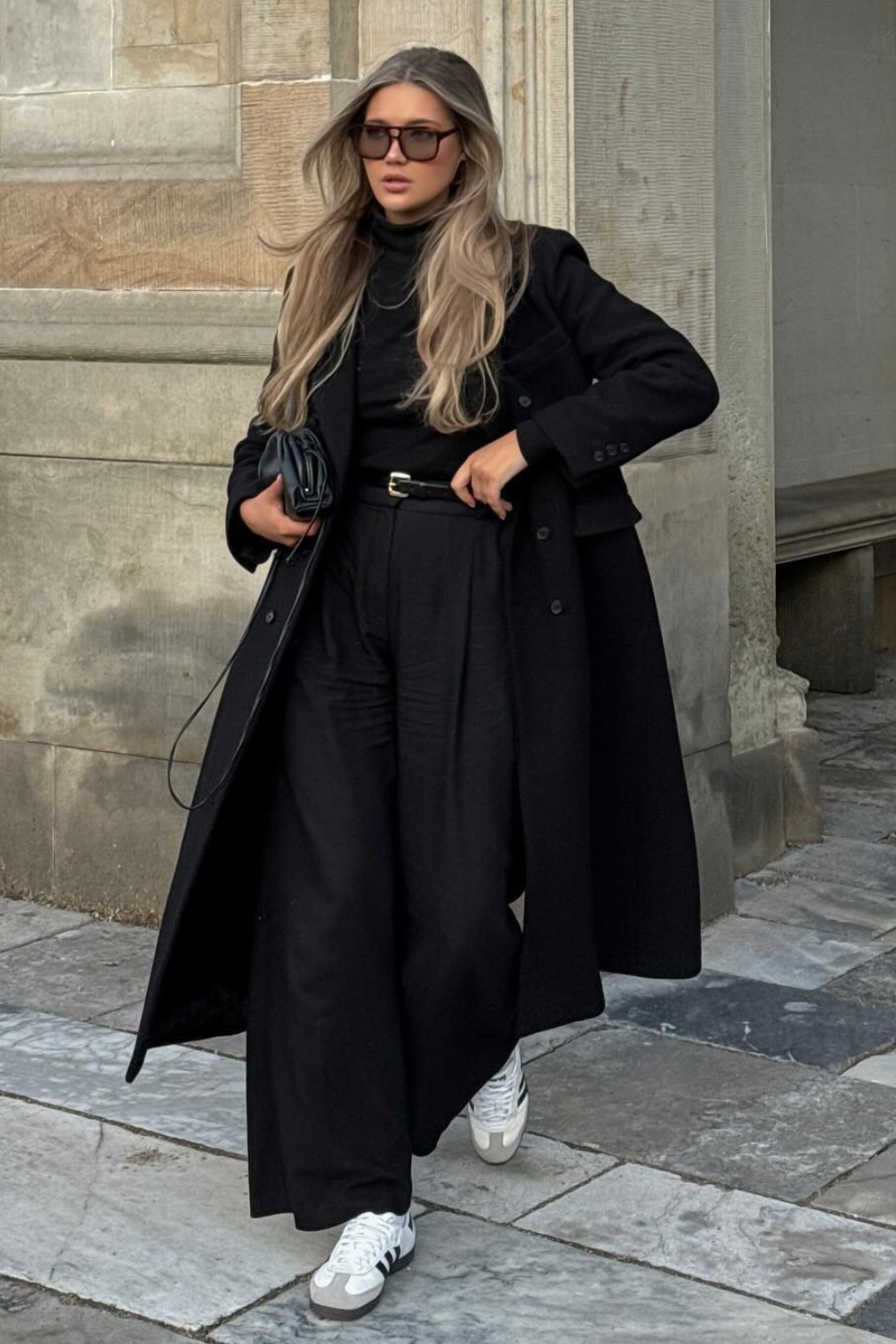 Black pants with black sweater and black coat outfit