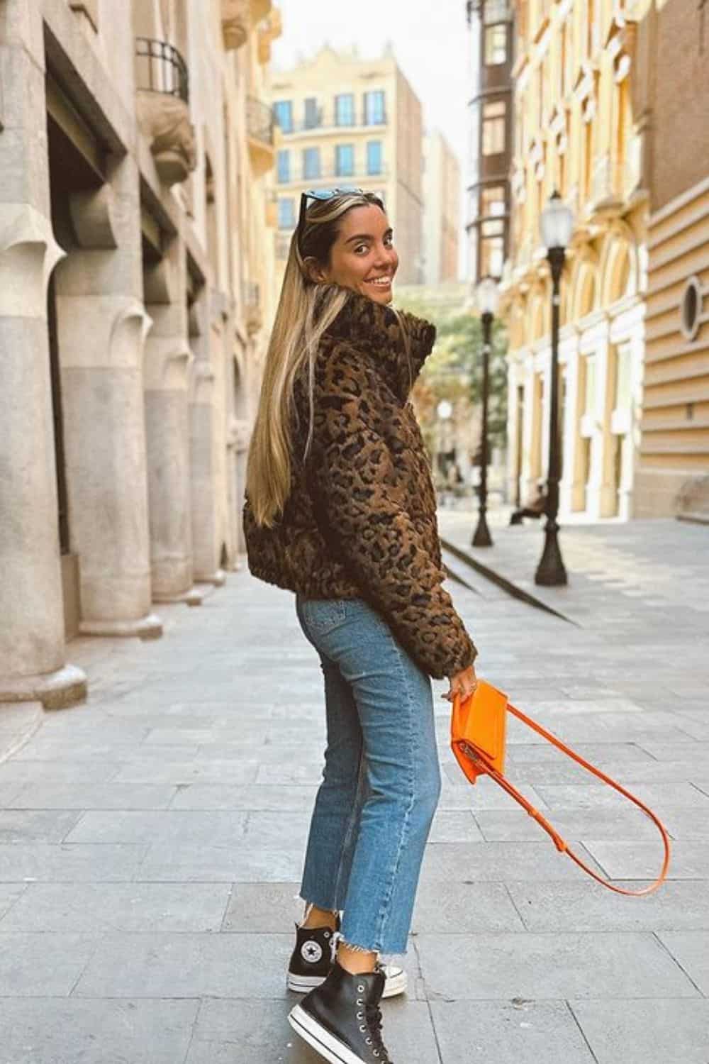 How to style animal prints with animal print puffer, jeans, sneakers, and a pop of color bag