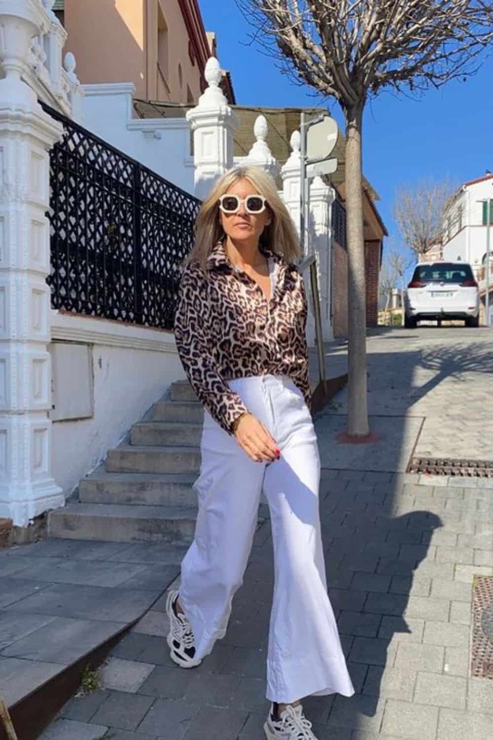 How to style animal prints with animal print blouse, white pants, sneakers and statement sunnies